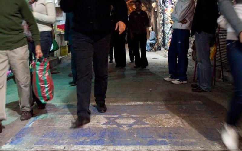 الأمن يستدعي ستينيّ لرسمه علم "إسرائيل" على باب محله